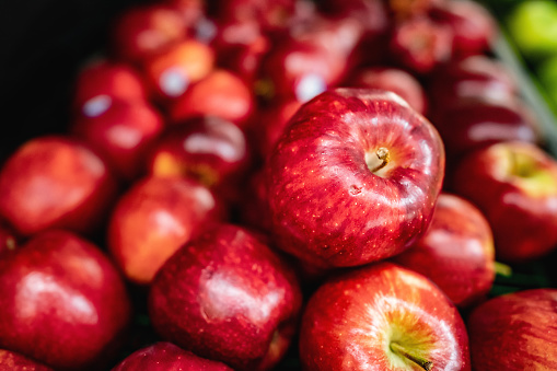 Delicious red apples on retail display at supermarket - No people